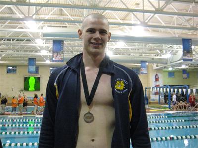 Sophomore Jake Bolton receives a bronze medal at the SWC Championships in the 100 Breaststroke.  